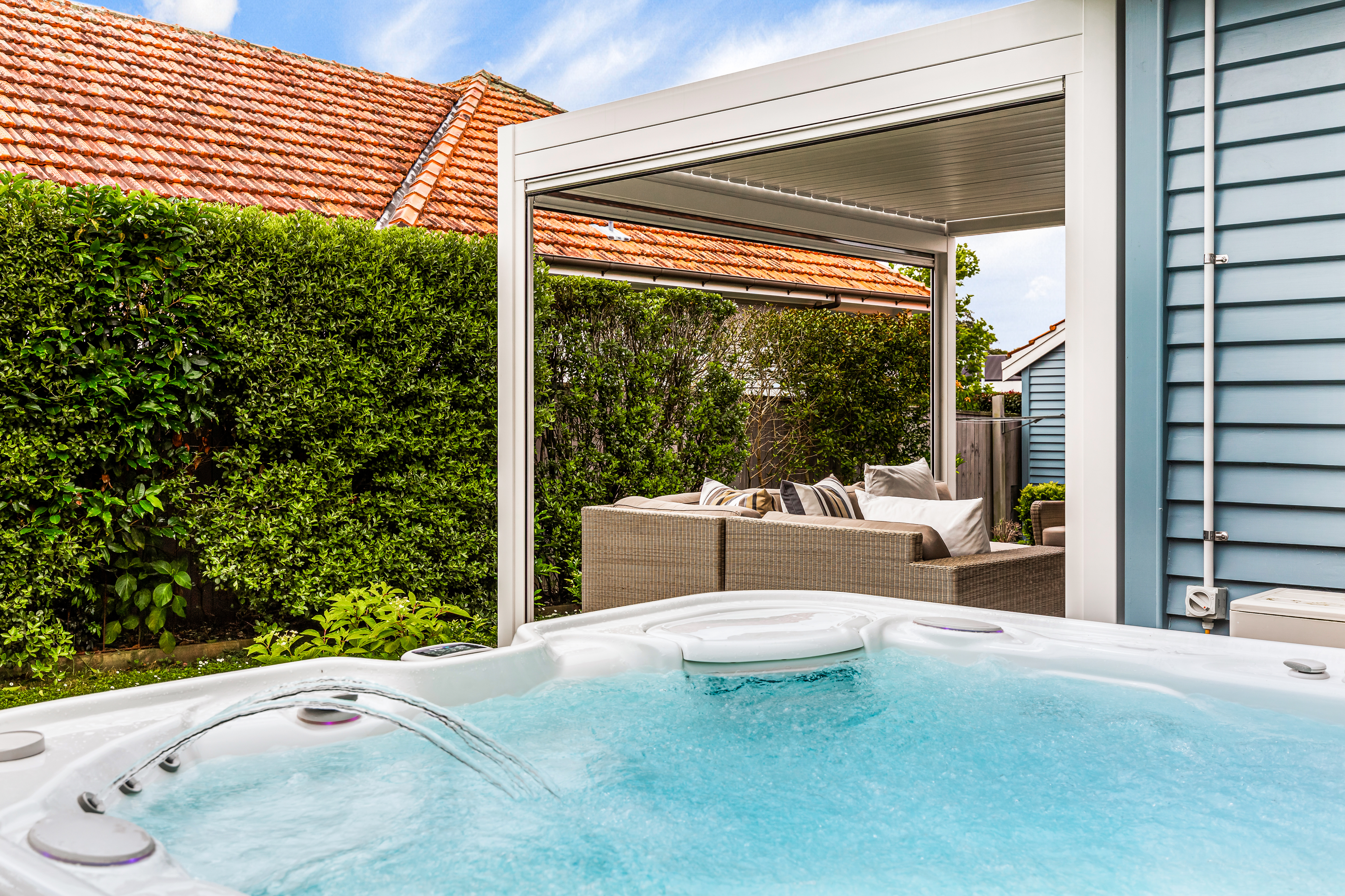 Covered outdoor entertaining area with spa pool Hobsonville Point Jev Matt