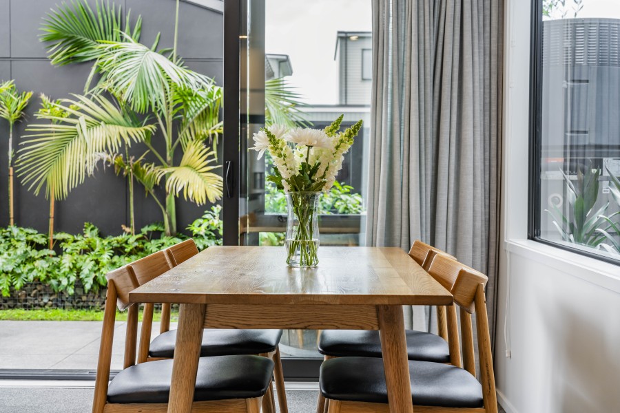 Dining area overlooking the landscaped courtyard   Hobsonville Point   Jev Matt