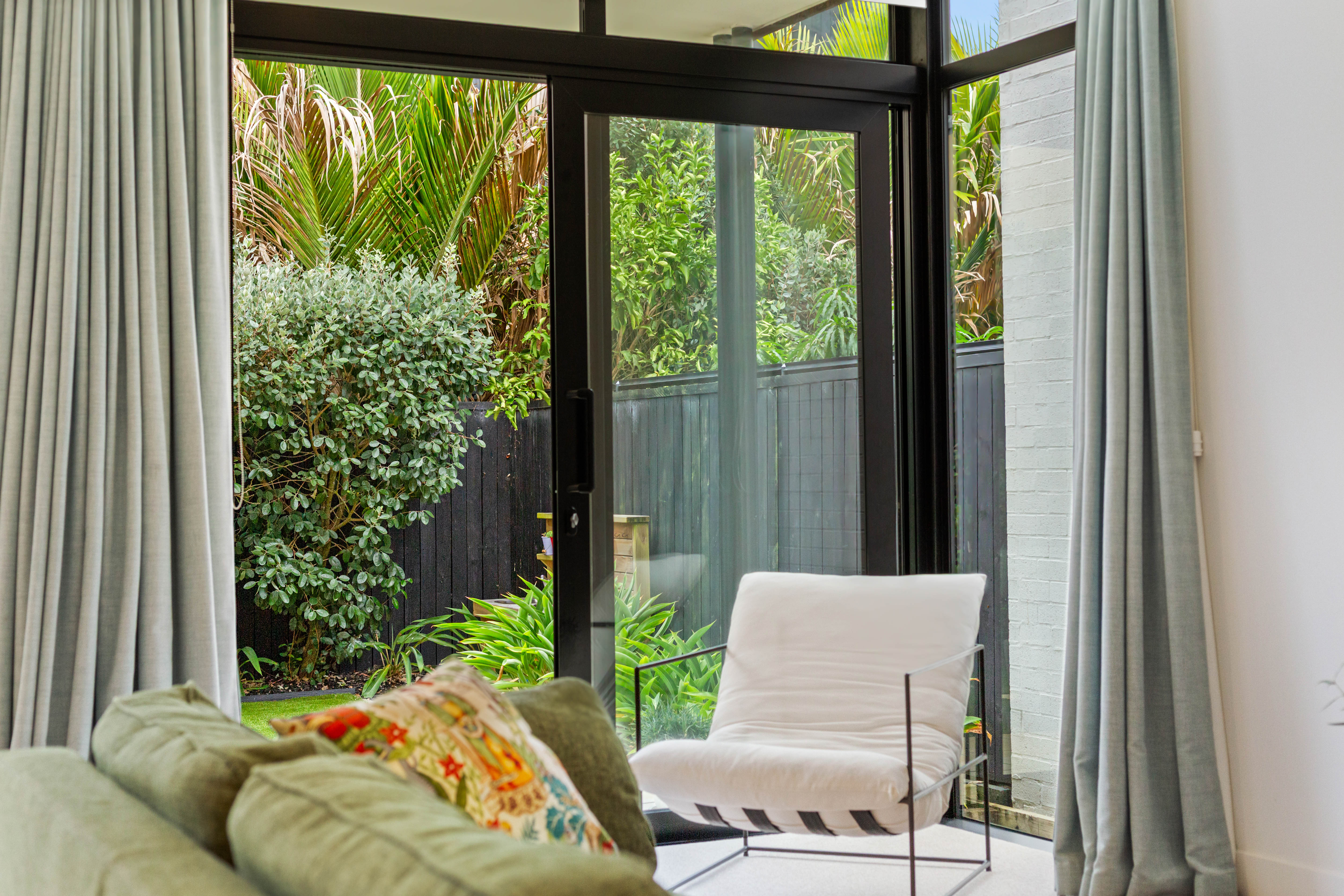 Floor to ceiling glazing overlooking private landscaped courtyard Hobsonville Jev Matt.jpg