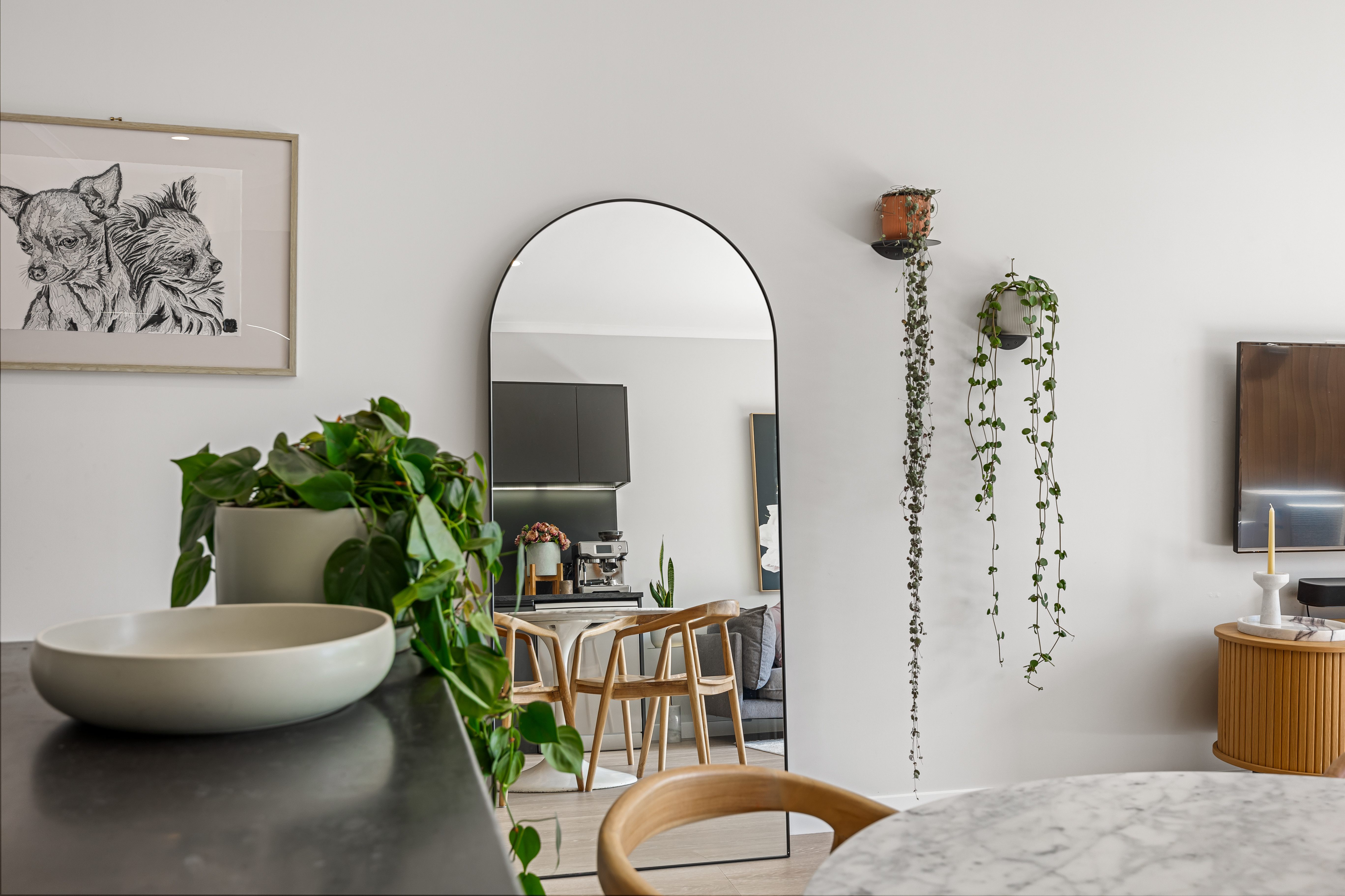 Light filled open plan living and dining with statement arched mirror Hobsonville Point Jev Matt v2.jpg