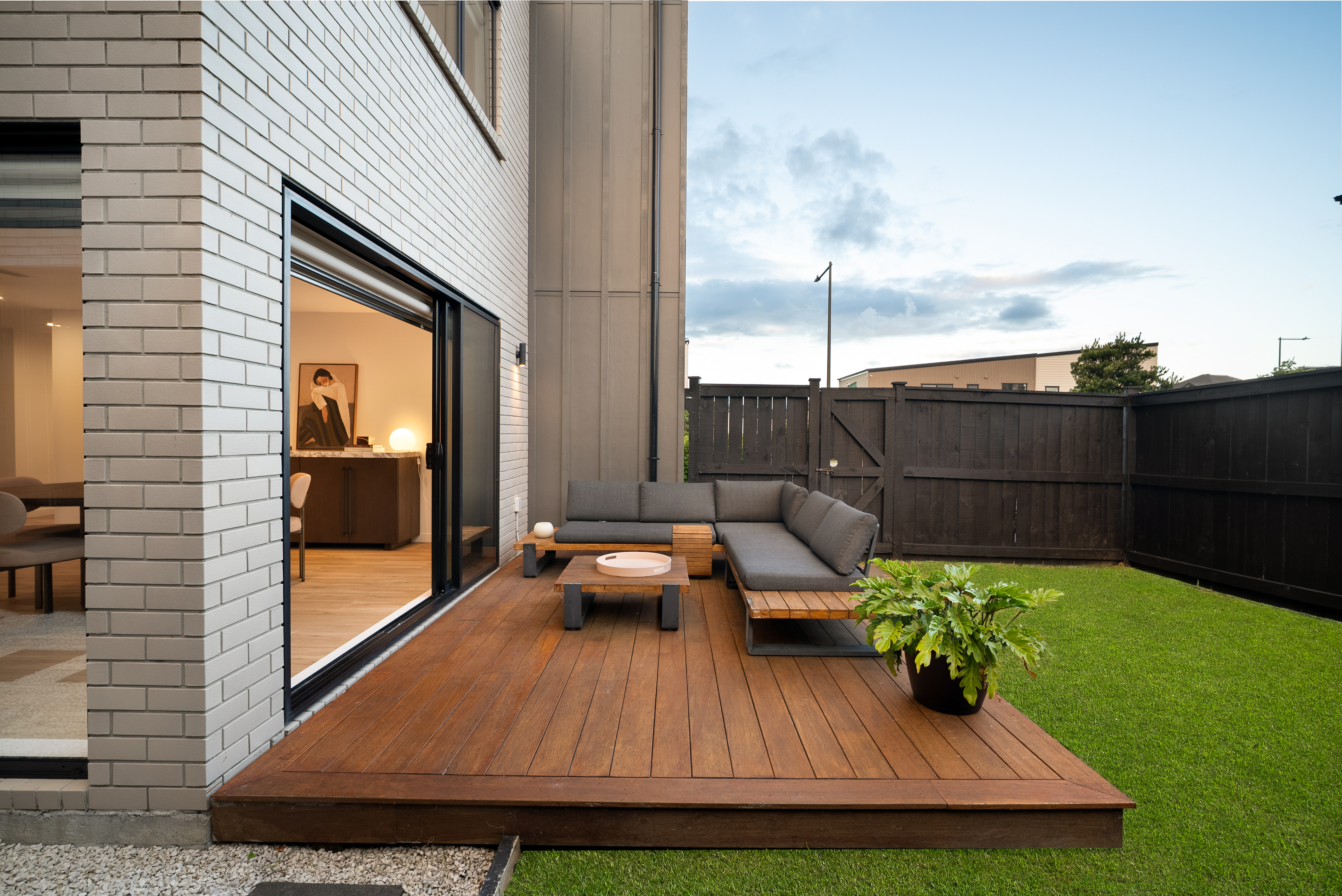 Private deck with outdoor lounge and easy care lawn Hobsonville Jev Matt.jpg