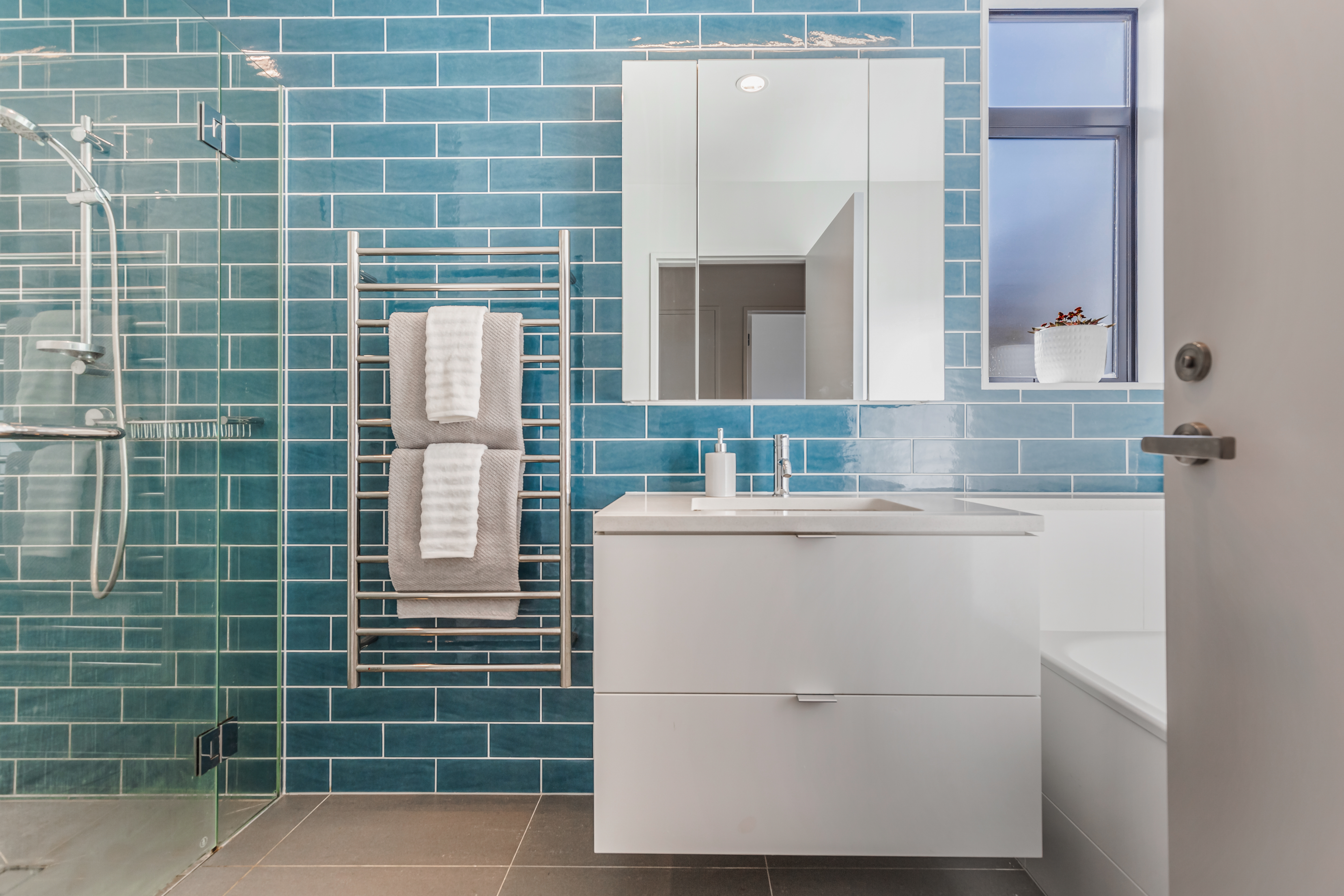 Willis Bond bathroom with blue tiles in Hobsonville Point   Jev Matt