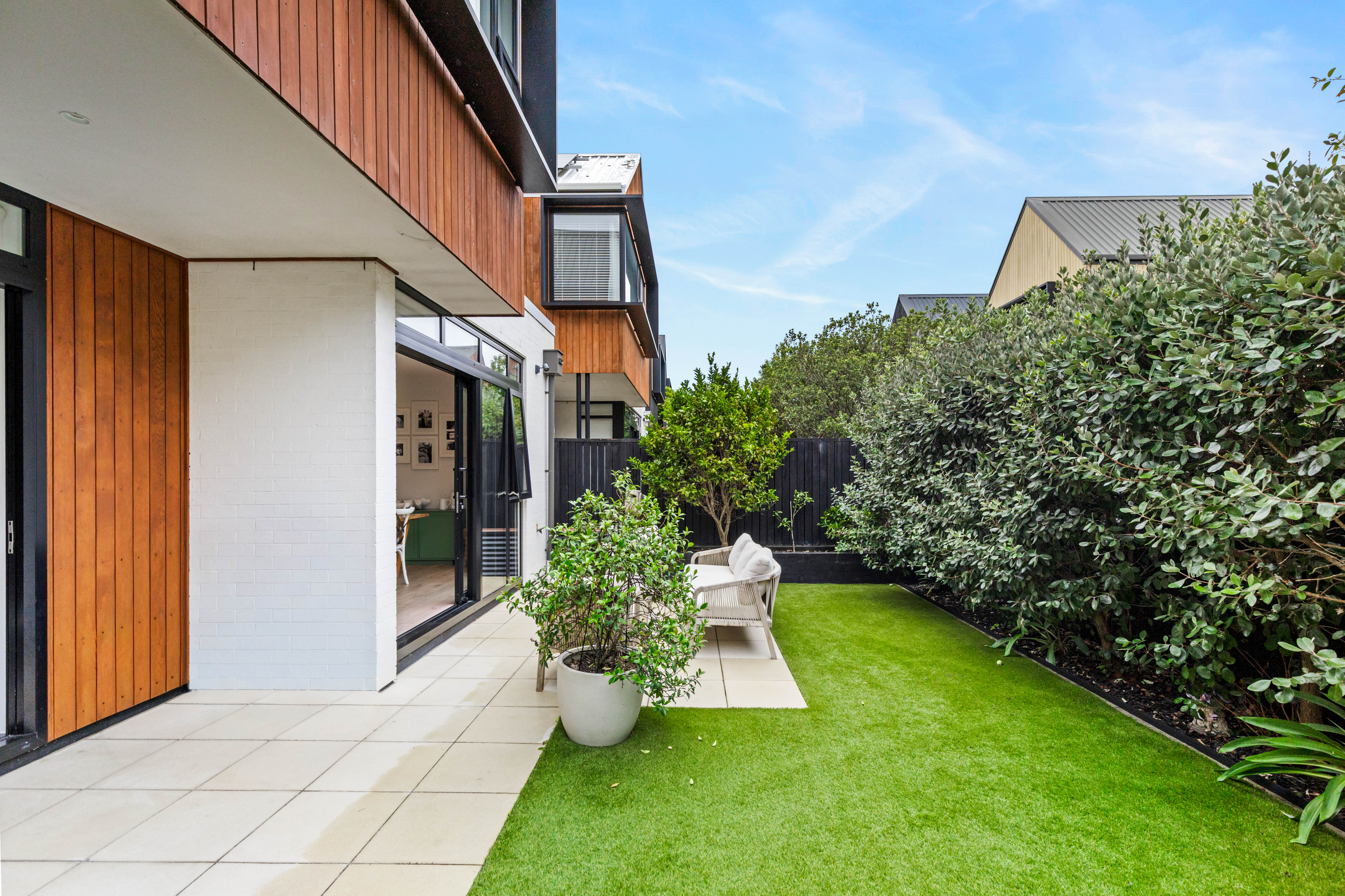 Willis Bond courtyard with landscaped lawn and sheltered outdoor living Hobsonville Jev Matt.jpg